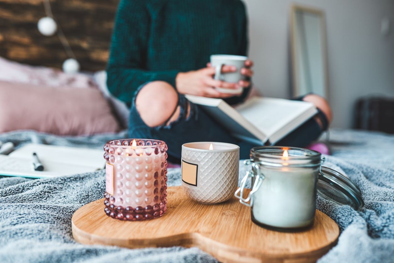 Woman reading with candles around her